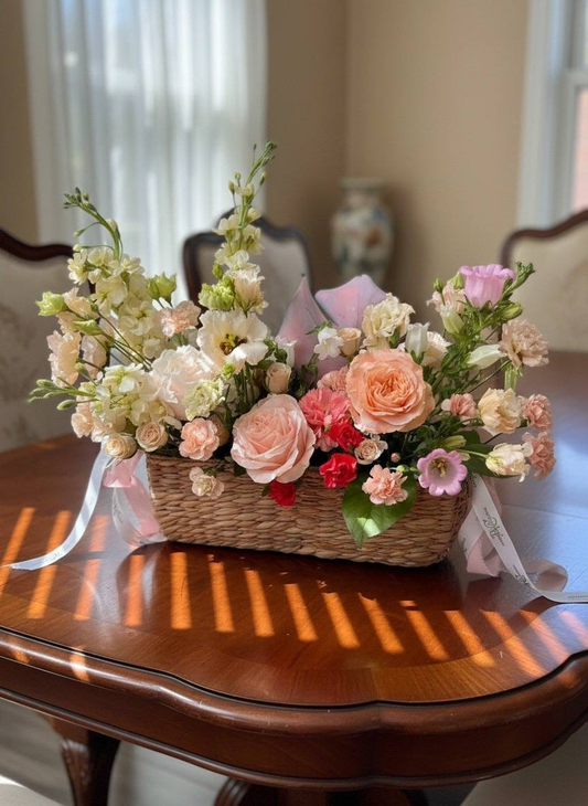 Floral arrangement in a woven basket on a wooden table