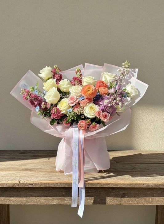 Bouquet of flowers on a wooden table with a neutral background